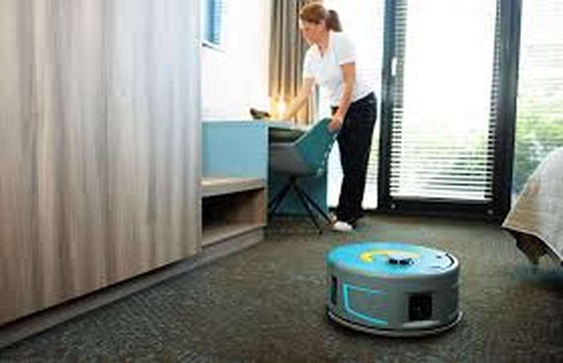 Co-botic 1900 vacuuming a hotel room